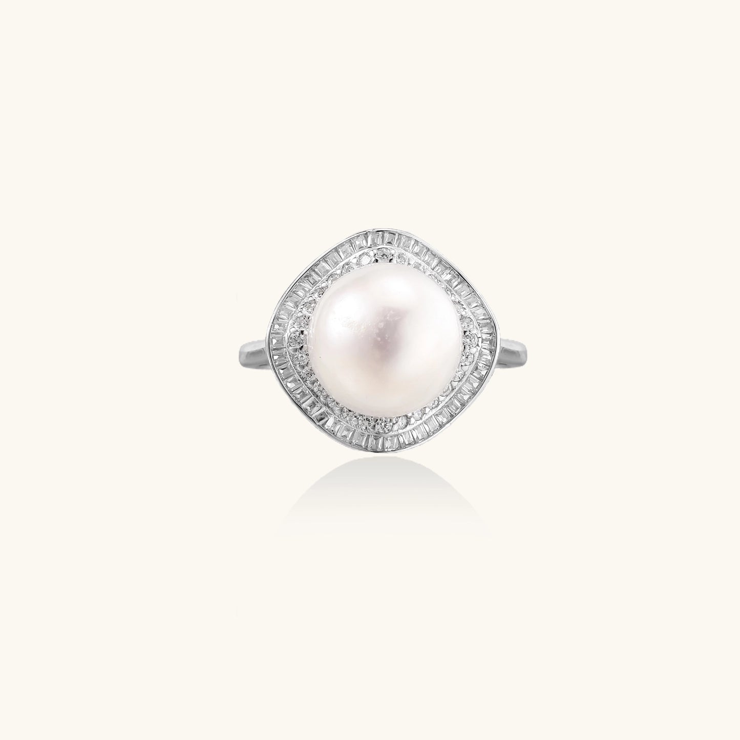 Sterling silver ring with 11mm freshwater pearl surrounded by double diamond halo on white background.