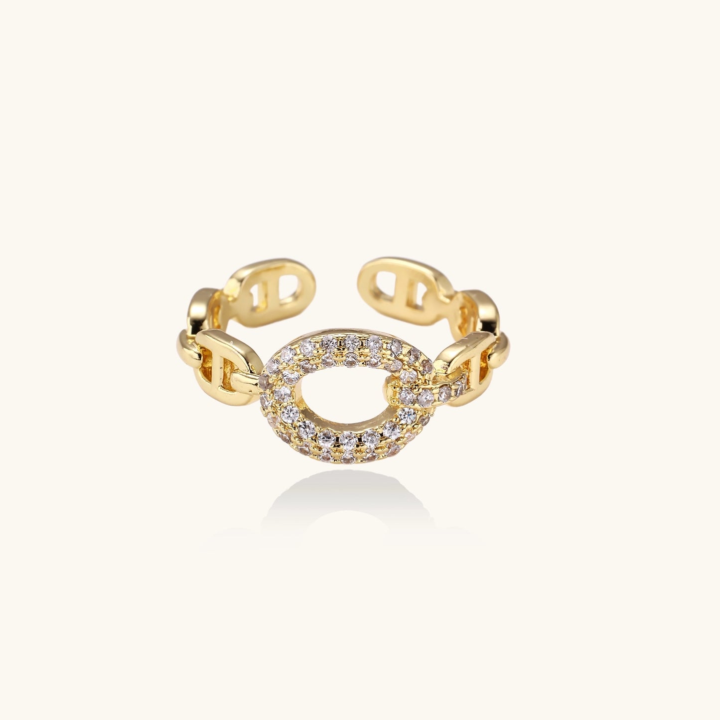 Gold-plated brass chain-link ring with cubic zirconia oval centerpiece, showing adjustable open-back design.