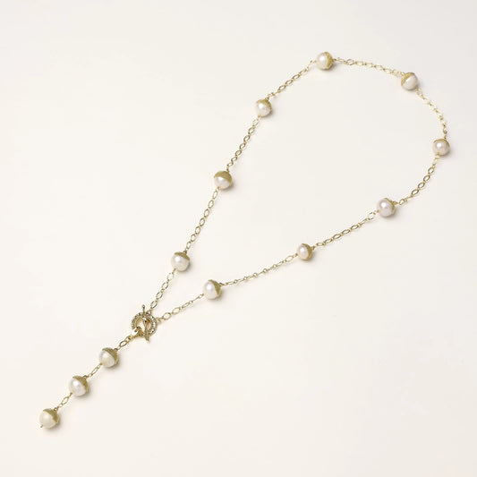Long gold-plated lariat necklace featuring baroque pearls with metal caps arranged in elegant Y-shape design