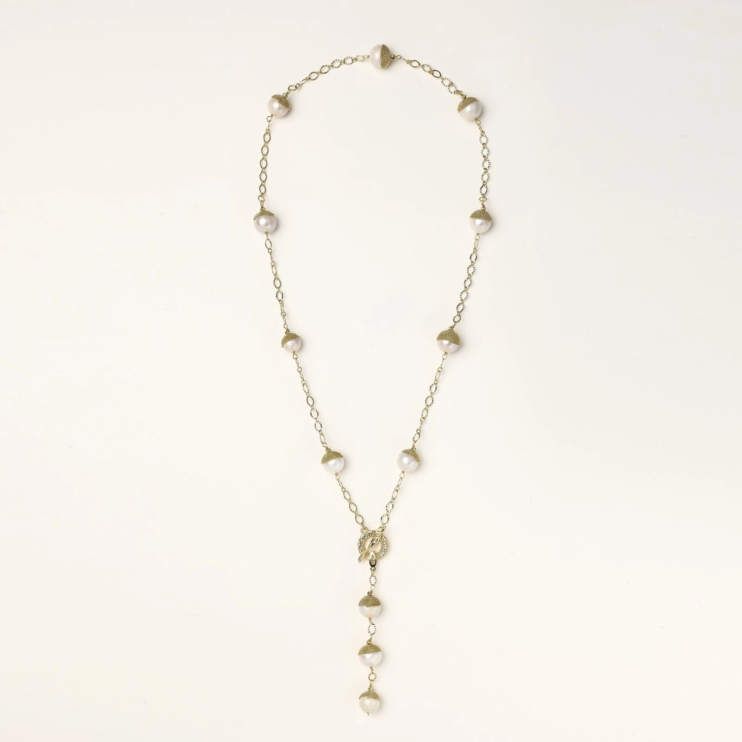 Long gold-plated lariat necklace featuring baroque pearls with metal caps arranged in elegant Y-shape design