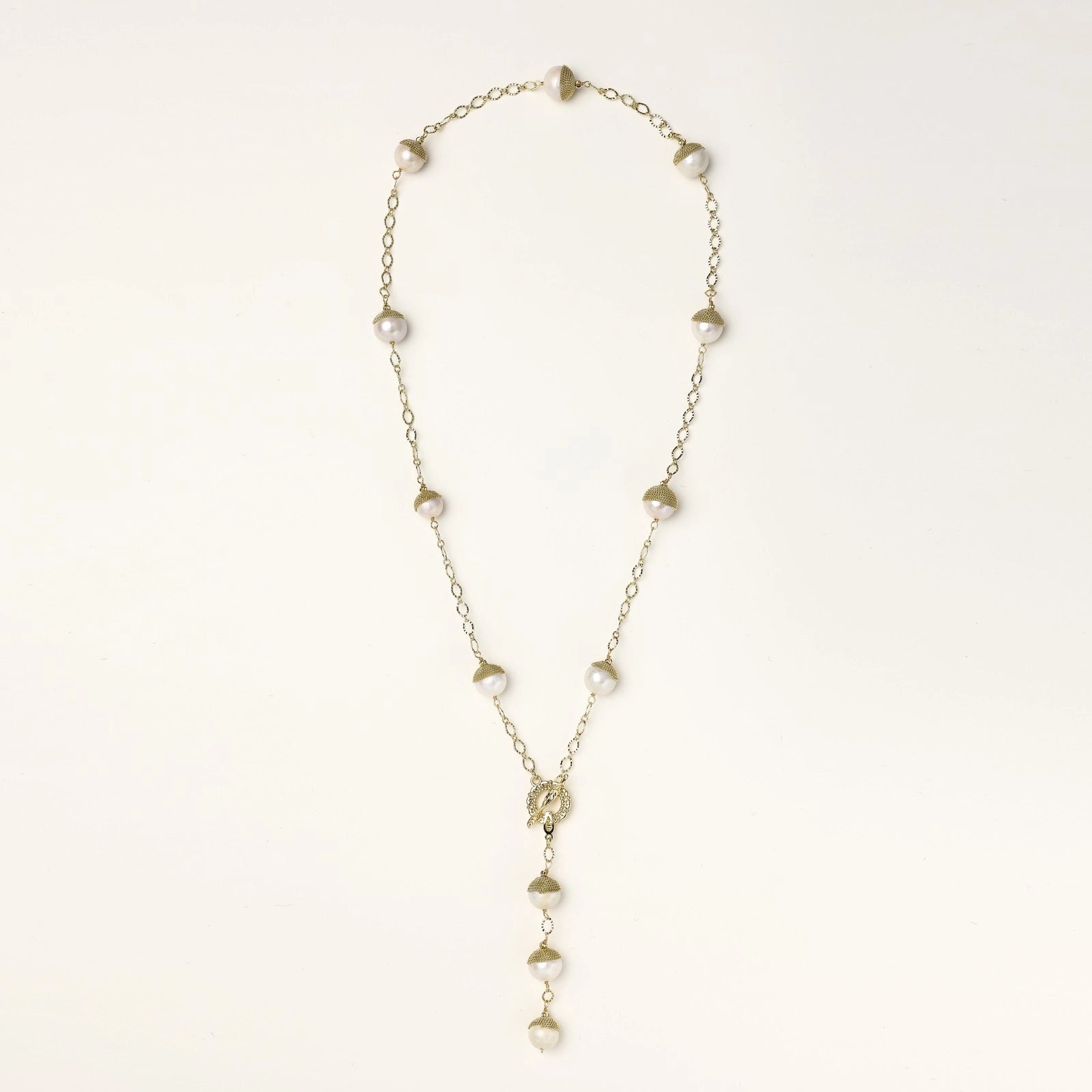 Long gold-plated lariat necklace featuring baroque pearls with metal caps arranged in elegant Y-shape design