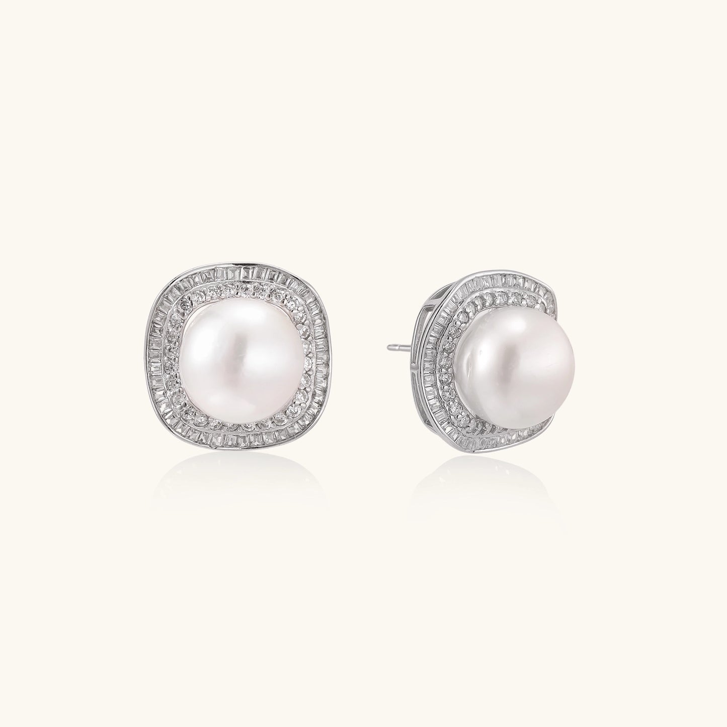 Sterling silver stud earrings with round freshwater pearls surrounded by sparkling crystal halos on white background.