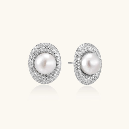 Sterling silver stud earrings with freshwater pearls surrounded by sparkling pavé crystals on white background.