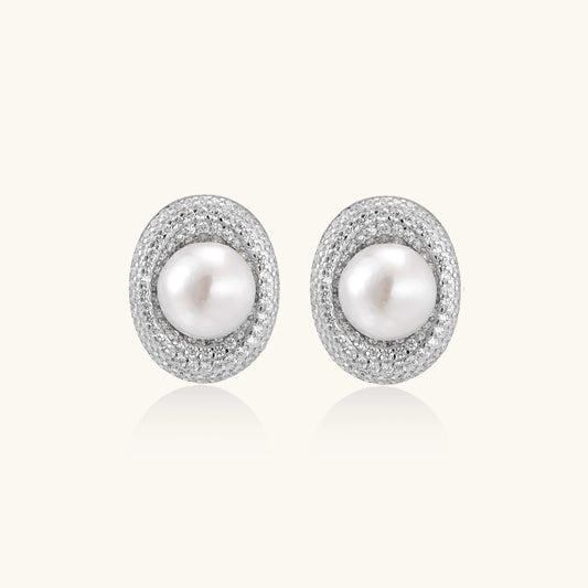 Sterling silver stud earrings with freshwater pearls surrounded by sparkling pavé crystals on white background.
