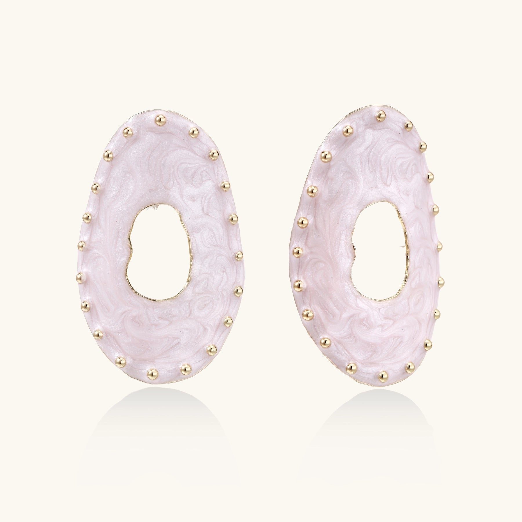 Oval lavender enamel earrings with gold studs around perimeter and cutout centers on white background