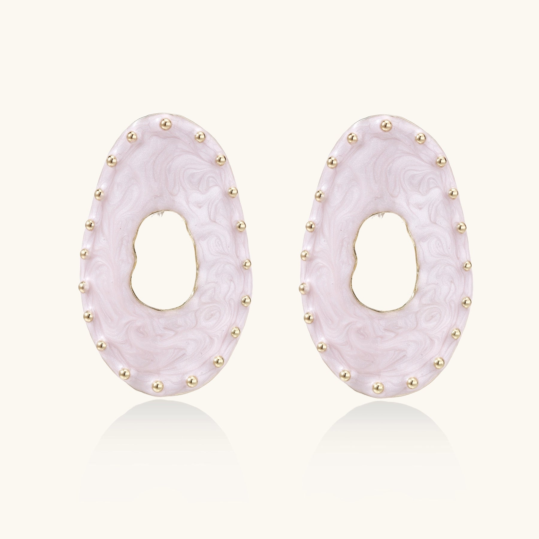 Oval lavender enamel earrings with gold studs around perimeter and cutout centers on white background