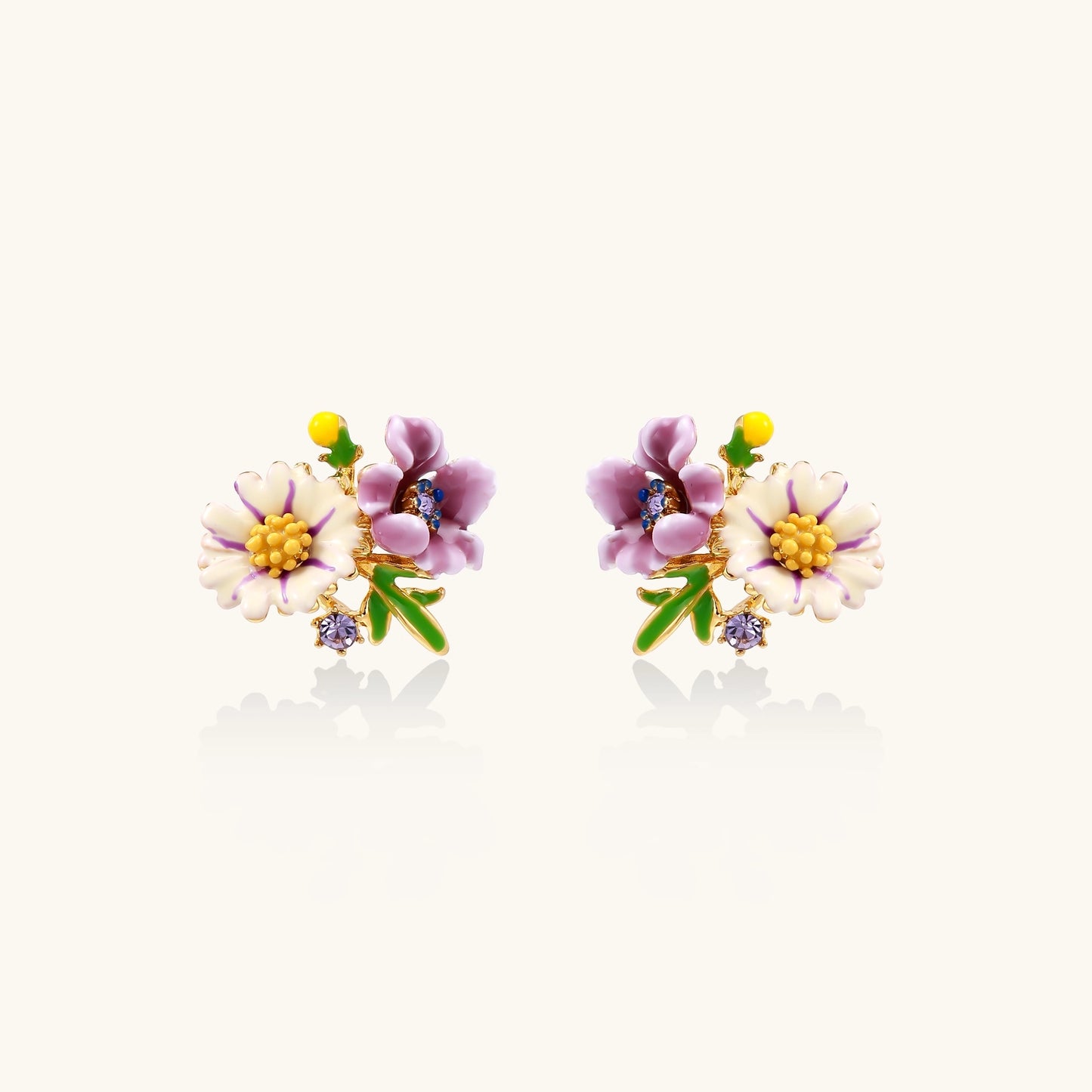 Delicate gold-plated stud earrings featuring white daisy and purple flowers with green leaves and crystal accents