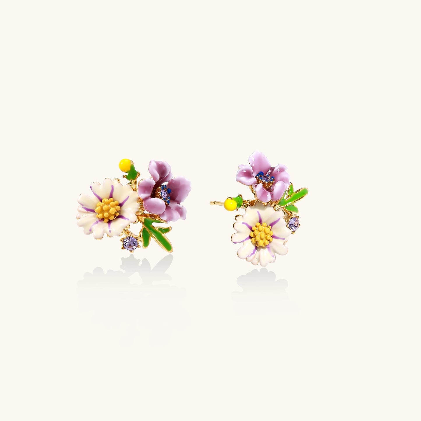 Delicate gold-plated stud earrings featuring white daisy and purple flowers with green leaves and crystal accents