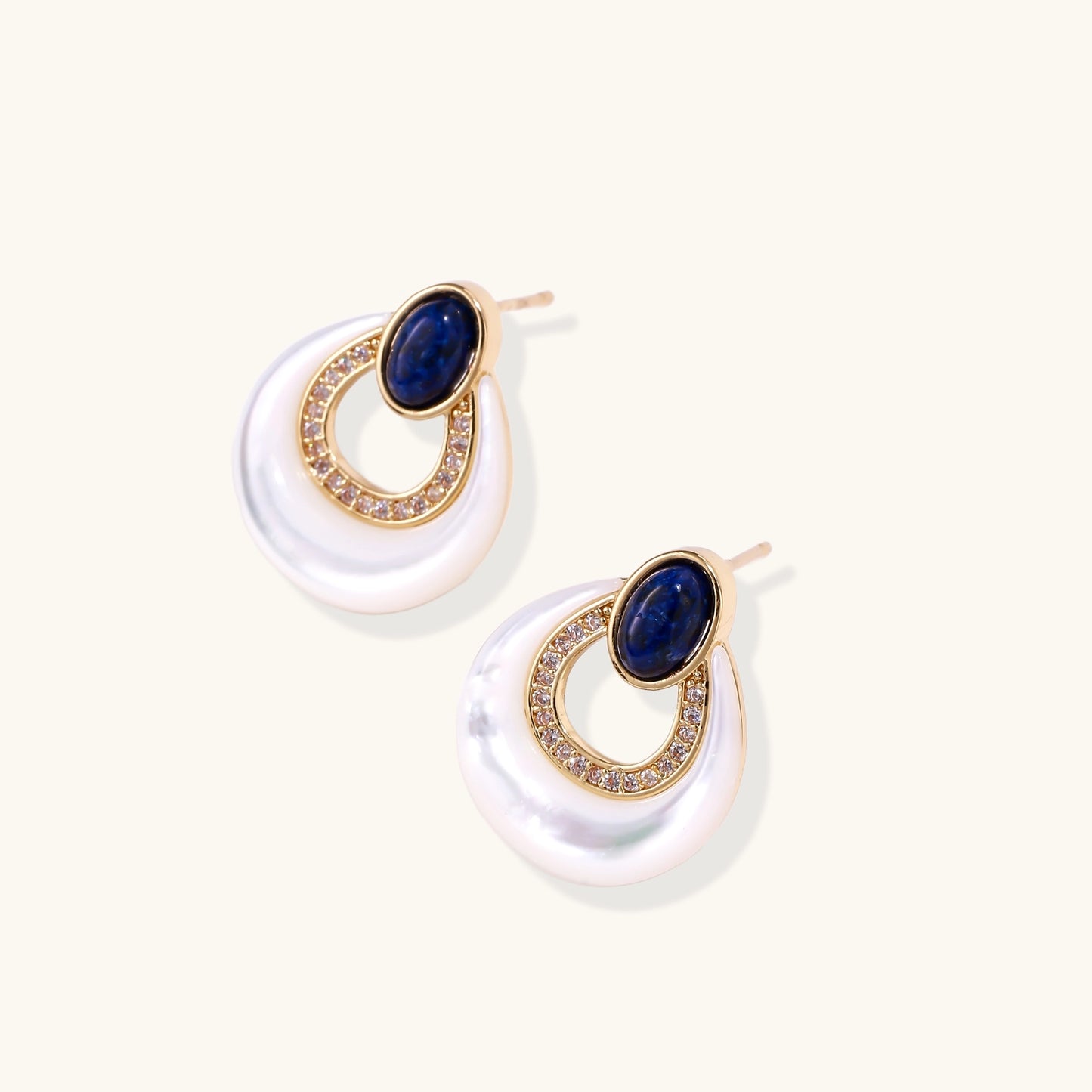Gold-plated drop earrings featuring blue lapis lazuli ovals, diamond-studded circles, and iridescent mother of pearl teardrops