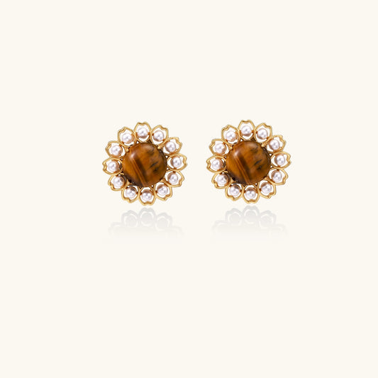 Gold-plated stud earrings with round tiger's eye stones surrounded by small pearls in a floral pattern.