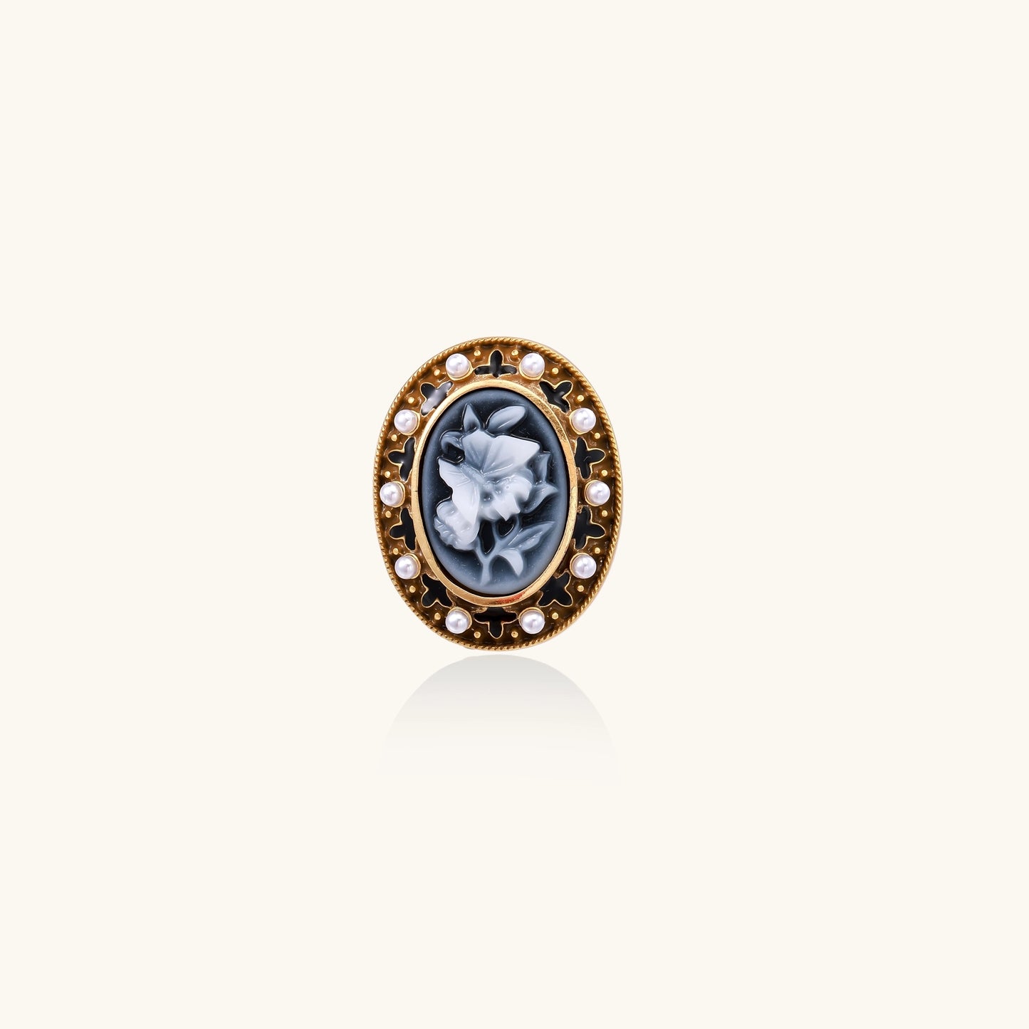 Oval cameo ring with blue-grey floral design surrounded by white shell pearls in gold-plated brass setting