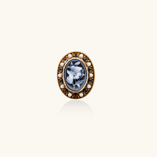 Oval cameo ring with blue-grey floral design surrounded by white shell pearls in gold-plated brass setting