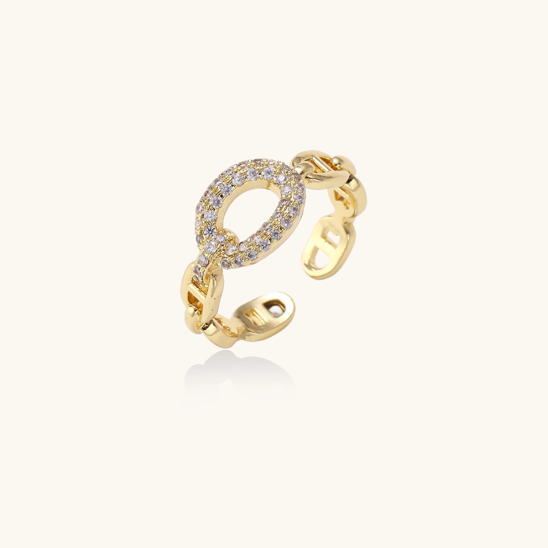 Gold-plated brass chain-link ring with cubic zirconia oval centerpiece, showing adjustable open-back design.